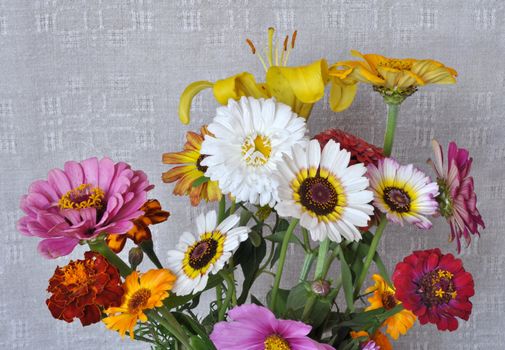A bouquet of garden flowers on the background of an old linen canvas. August, the Central Russia