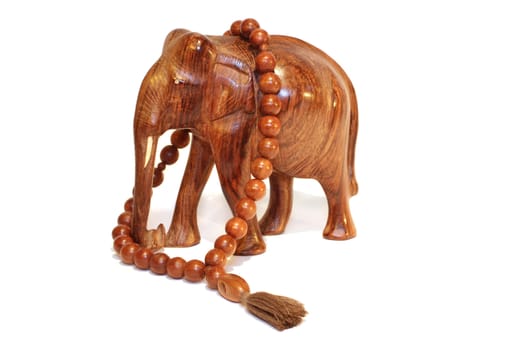 A wooden elephant and wooden beeds isolated