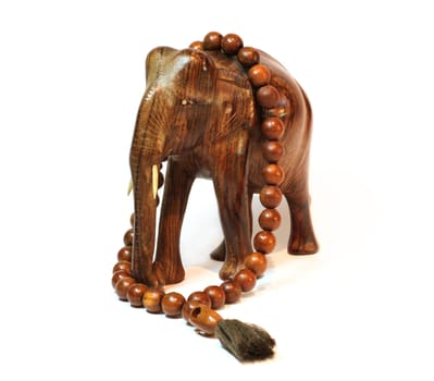 A wooden elephant and wooden beeds isolated