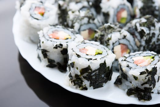 Delicious sushi with salmon, avocado and shrimp