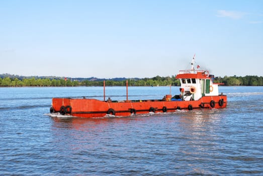 red barge with Indonesia flag on the high seas