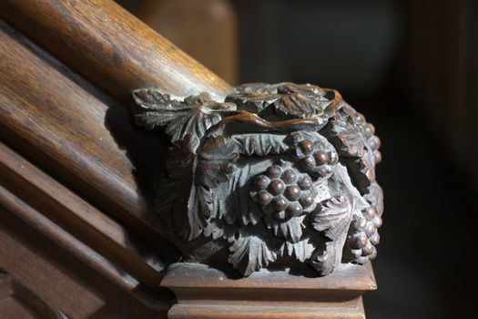 Detail (grapes) of wooden staircase to pulpit in Chetwode parish church, UK