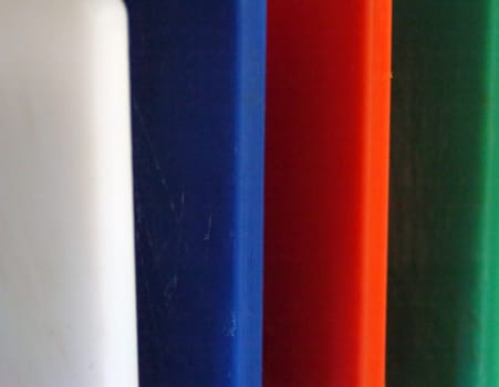 close up of different colored chopping boards, requierement for food hygiene, i.e. blue for raw fish