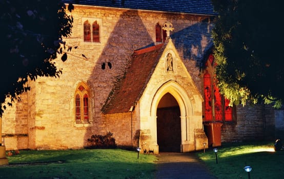 entry of old english country church by night