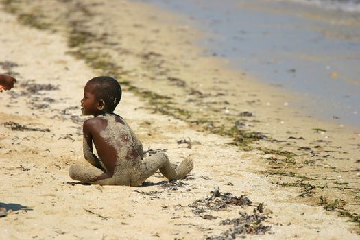 Young kid playing on the beach at Ifaty, Madagascar
