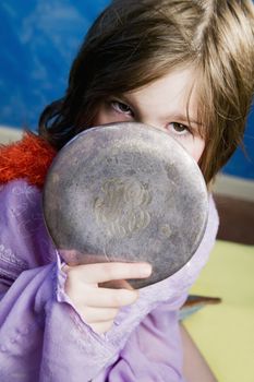 Little Girl Playing Dress-Up with an Antique Handheld Mirror