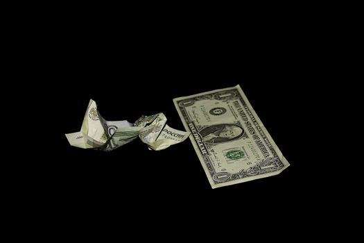 Crushed banknote in 10 roubles and a banknote in 1 dollar on a black background
