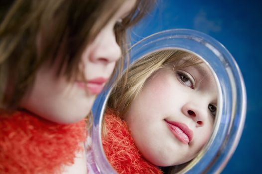 Little Girl Playing Dress-Up Looking in a Handheld Mirror