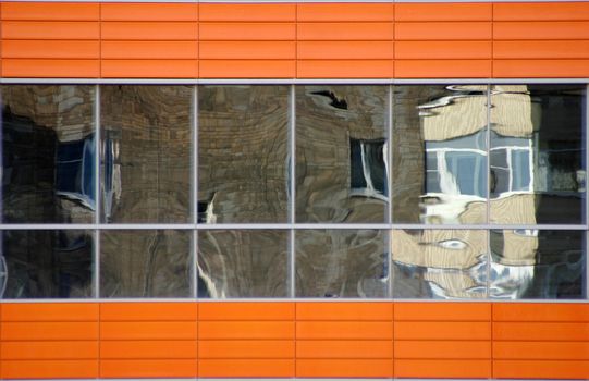 Distorted reflections of a brick wall in windows