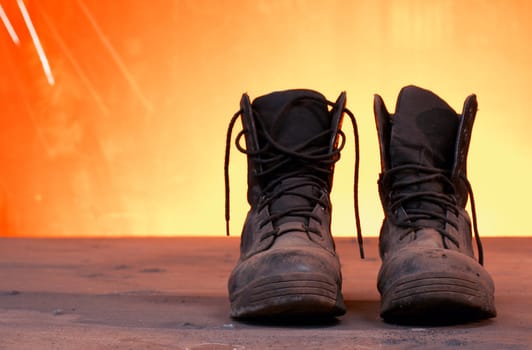 a picture of black work boots on a steel table