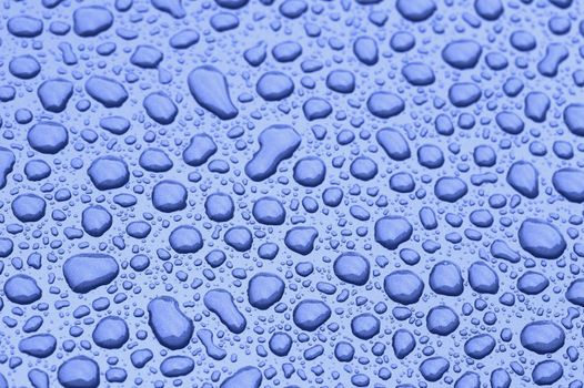 a picture of water drops on a metal surface