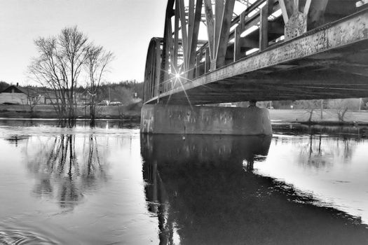 A bridge across the river at sunset