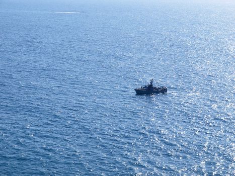 Navy patrol boat in action with blue ocean background
