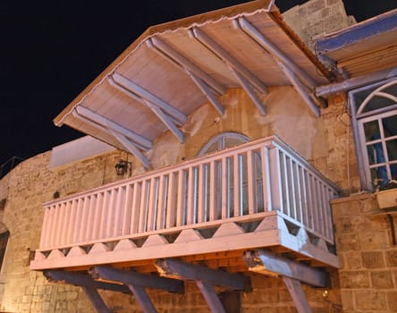 Mediterranean Italian style balcony terrace of a stone house at night