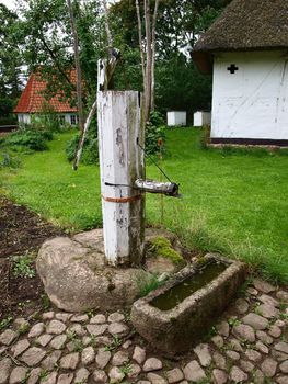 Old vintage well water pump in village farm Denmark   
