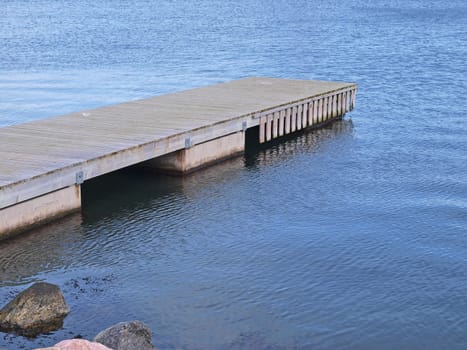 Small wooden jetty dock pier in a marina       
