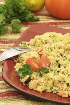 Mediterranean couscous salad on a colorful tablecloth