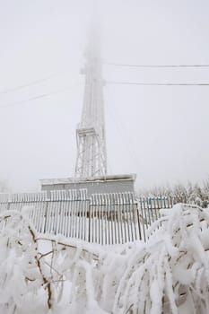 Radio transmitting tower frozen with a huge amounts of snow