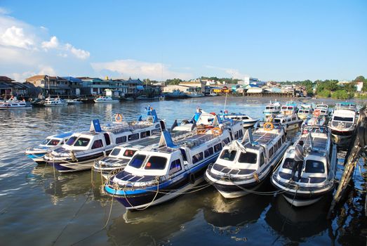 many long speed boat for public water transportations at anchor