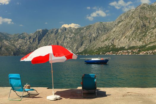 Bright umbrella on beautiful Kotor Bay Montenegro in the summer