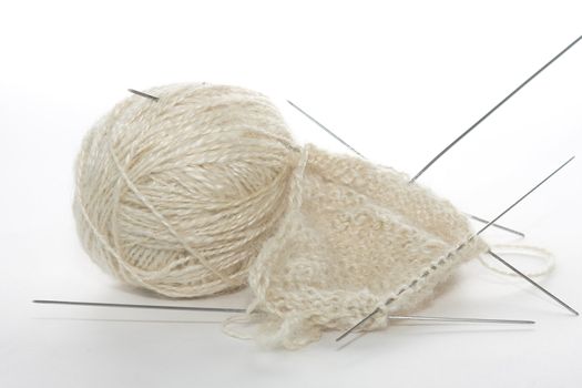 White woolen a thread and the unfinished socks