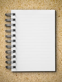 Open single blank white note book vertical on particle board background