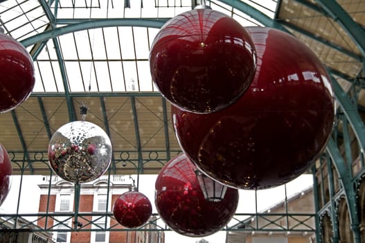 Huge red glass balls hanging from the roof