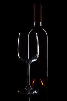 Glass and bottle with red wine