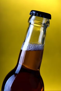 Glass bottle on a yellow background .