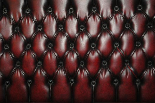 texture and pattern of red dark leather seat upholstery