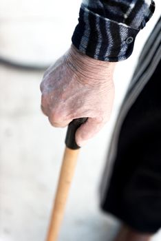 An old man uses a stick for walking