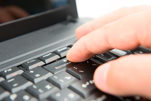 Hand on keyboard pushes button backspase