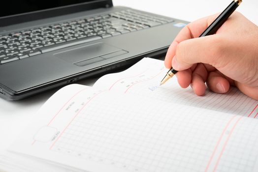 Businessman taking notes and planning in a meeting