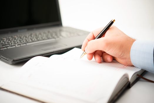 Businessman taking notes and planning in a meeting