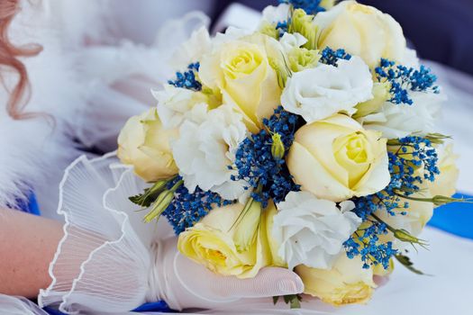 Wedding bouquet. Bridal bouquet lying on her lap.