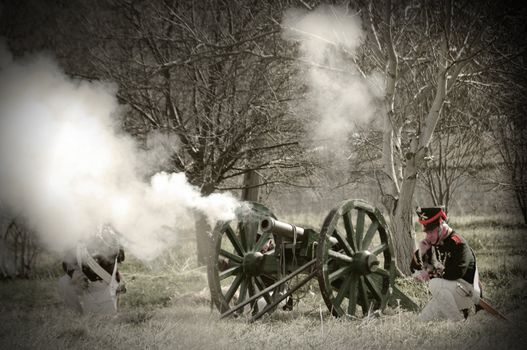 IGANIE, POLAND - APRIL 16: Members of Historic Artillery Group fire a cannon at Battle of Iganie (1831) reenacted on a battlefield on 180th anniversary on April 16, 2011 in Iganie, Poland