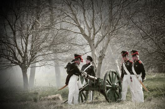 IGANIE, POLAND - APRIL 16: Members of Historic Artillery Group load a cannon at Battle of Iganie (1831) reenacted on a battlefield on 180th anniversary on April 16, 2011 in Iganie, Poland