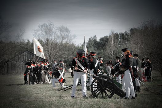 IGANIE, POLAND - APRIL 16: Members of Historic Artillery Group load a cannon at Battle of Iganie (1831) reenacted on a battlefield on 180th anniversary on April 16, 2011 in Iganie, Poland