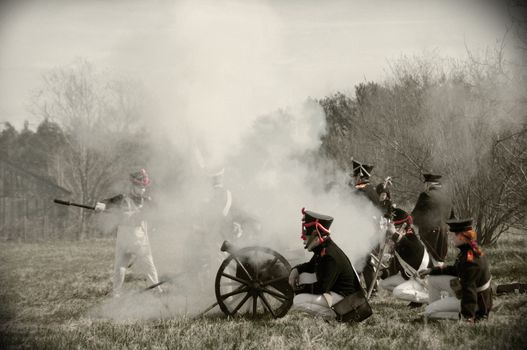 IGANIE, POLAND - APRIL 16: Members of Historic Artillery Group fire a cannon at Battle of Iganie (1831) reenacted on a battlefield on 180th anniversary on April 16, 2011 in Iganie, Poland