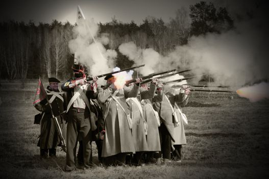 IGANIE, POLAND - APRIL 16: Members of 2nd Infantry Regiment of Duchy of Warsaw fire rifles at Battle of Iganie (1831) reenacted on a battlefield on 180th anniversary on April 16, 2011 in Iganie, Polande, Poland