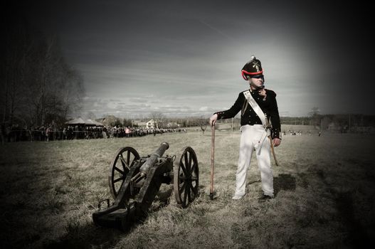 IGANIE, POLAND - APRIL 16: Member of Historic Artillery Group standing next to a cannon at Battle of Iganie (1831) reenacted on a battlefield on 180th anniversary on April 16, 2011 in Iganie, Poland