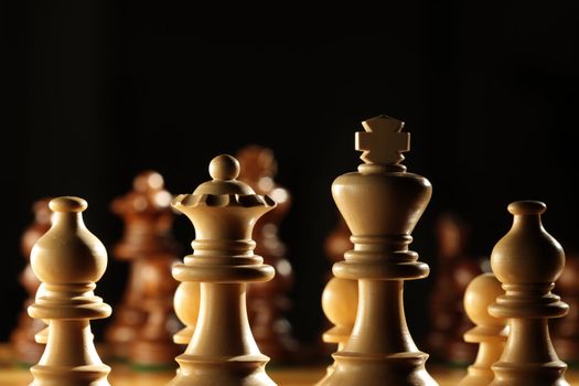 View from behind the white pawns on a chess board
