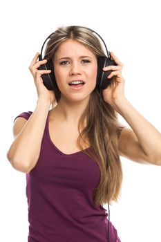 Cheerful woman listening music with earphones, singing and dancing, on white