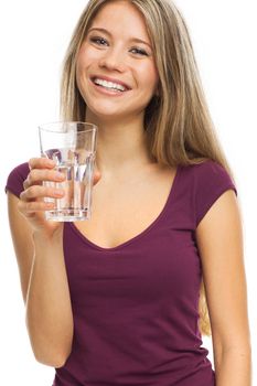 Nice young woman drinking a glass of water, on white