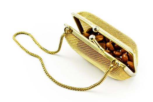 Golden metallic purse with coffee beans isolated on white