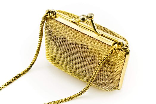 Golden metallic purse isolated on white
