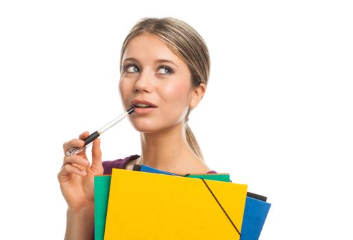 Young woman holding folders and a pen, smiling and looking up, on white