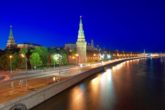 Kremlin embankment of the Moskva River and the Vodovzvodnaya (Water) Tower of the Moscow Kremlin at night. Shot from the Big Stone Bridge. Moscow, Russia.