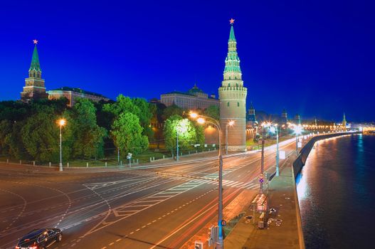 Kremlin embankment of the Moskva River and the Vodovzvodnaya (Water) Tower of the Moscow Kremlin at night. Shot from the Big Stone Bridge. Moscow, Russia.