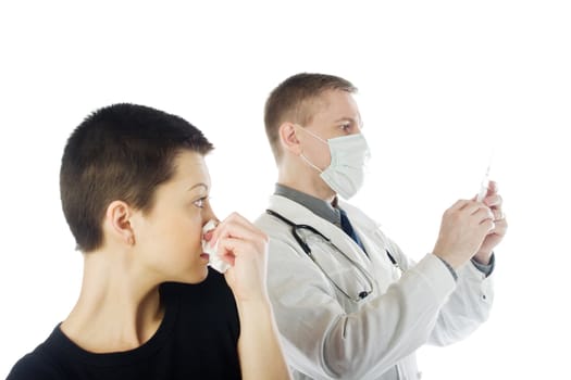 Woman with tissue paper watches how a doctor in gauze mask preapres a syringe